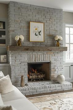 a living room filled with furniture and a fire place in front of a brick fireplace