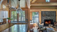 a living room filled with furniture and a fire place in the middle of a kitchen