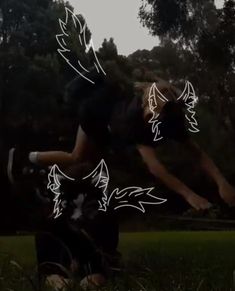 a person jumping in the air with their arms spread out to catch a frisbee