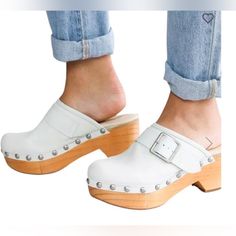 Details Distressed Leather Studded Slip-On Clog Cushioned Footbed 21/2" Stacked Wood Heel With A 1" Platform Item No. 868330b1270363 Style Ob1270363 | Sku 965510 Fabric & Care Due To The Nature Of Leather/Suede, Small Variances Of Color In The Skin May Occur, This Is In No Way Considered A Defect. These Are Inherent Characteristics Of Leather/Suede And Will Enhance The Individual Look Of Your Garment. Imported Msrp$178 Bae Clogs, Free People Clogs, White Clogs, Slip On Wedge Sandals, Leather Clog, Black Leather Mules, Suede Clogs, Black Platform Heels, Wood Heel