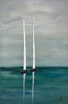 two sailboats floating in the ocean on a cloudy day