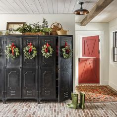 a black metal locker with wreaths on it