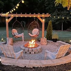 an outdoor fire pit with chairs around it