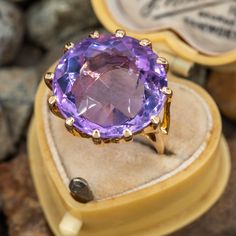 This beautiful cocktail ring features a round cut lilac amethyst in a 12-prong setting. It is crafted in 10k yellow gold and currently sized to a 5.5. There is a small chip located near one of the prongs. Heirloom Solitaire Purple Amethyst Ring, Lavender Amethyst Ring For Formal Occasions, 14k Gold Brilliant Cut Purple Amethyst Ring, Formal Lavender Amethyst Ring Hallmarked, Formal Lavender Hallmarked Amethyst Ring, Formal Purple Amethyst Ring With Round Stone, Classic Lavender Amethyst Ring With Prong Setting, Lavender Amethyst Ring With Round Cut For Formal Events, Lavender Amethyst Ring With Round Cut For Formal Occasions