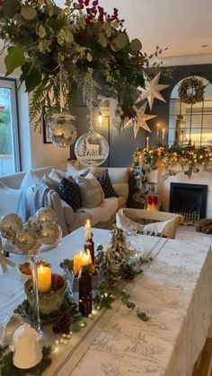 a living room filled with lots of furniture and christmas decorations on top of a table