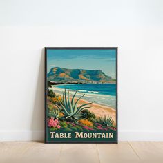 a table mountain poster is on the wall next to a wooden floor in front of a white wall