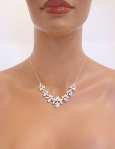 "Unique and radiant, this silver plated necklace and earring set features a lovely arrangement of cubic zirconias in various shapes and sizes. A versatile and beautiful addition to your classic, modern, or vintage-inspired wedding. This necklace measures 16 inches and extends to 18 inches. Matching earrings measure 3/4\" long. You can choose a backdrop for this piece as well, please choose from the drop down menu. Matching bracelet: https://www.etsy.com/listing/241089352/crystal-bridal-bracelet- Sparkling Diamond Necklace For Wedding, Elegant Sparkling Rhinestone Necklace With Cubic Zirconia, Elegant Sparkling Cubic Zirconia Rhinestone Necklace, Delicate Cubic Zirconia Necklace With Sparkling Stones, Delicate Necklace With Sparkling Cubic Zirconia, Elegant Rose Gold Crystal Bridal Necklace, Elegant Diamond Rhinestone Necklace For Gift, Elegant Sparkling Cubic Zirconia Diamond Necklace, Delicate Sparkling Diamond White Jewelry