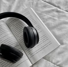 headphones resting on top of an open book