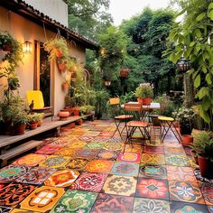 an outdoor patio with colorful tiles and potted plants