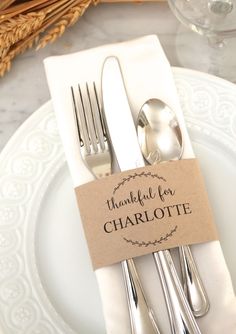 a white plate topped with silverware on top of a table