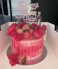 a birthday cake with pink frosting and roses