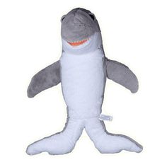 a stuffed shark toy is shown on a white background with an orange light in the mouth