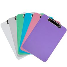 four different colored clipboards on top of each other with zippers attached to them