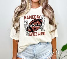 a woman with blonde hair wearing a game day tee