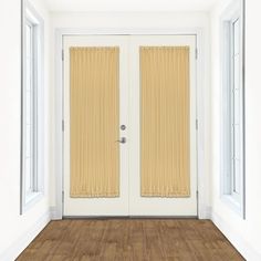 an empty room with two doors and yellow curtains on the window sill, in front of a wooden floor