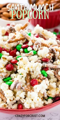 a red bowl filled with popcorn covered in candy