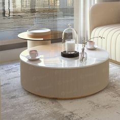 a coffee table with two cups on it