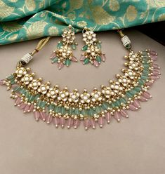 Indulge in the allure of understated luxury with in this beautiful set from our Traditional Collection, a testament to timeless sophistication and refined taste! This high quality designer pink and mintgreen kundan necklace set is sure to win you over!  Experience our classic dainty kundan set crafted with pink and mintgreen agate beads to attain a resplendent look.  Details: Necklace Width-1.75 Inches Earrings Length-2.75 Inches Weight of Each Earring-10 gms All products are manufactured using Green Fusion Kundan Necklace For Weddings, Fusion Style Kundan Necklace For Weddings, Fusion Kundan Wedding Sets, Fusion Style Kundan Wedding Sets, Kundan Jewellery Set, Kundan Necklace Set, Kundan Jewelry, Kundan Necklace, Bollywood Jewelry