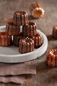 several small cakes are stacked on a plate