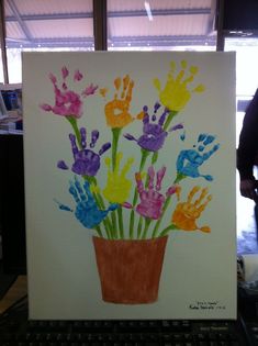 an art project with handprints of flowers in a pot