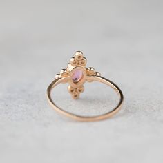 Unique art deco inspired pink tourmaline diamond ring comes in 100% recycled 14k solid rose gold. Accentuated with three beautiful diamonds clustered on both sides complementing the romantic beauty of pink tourmaline. Purchase this as an everyday ring or engagement ring for your special someone. This elegant ring will make every woman look and feel uniquely beautiful. * Stone: Ethically sourced genuine pink tourmaline * Stone size: ≈6mmx ≈4mm * Diamond total weight: ≈0.12ctw * Diamond quality: G Elegant Rose Gold Stackable Rings With Pink Sapphire, Elegant Pink 14k Gold Stackable Rings, Pink Birthstone Promise Ring With Rose Cut Diamonds, Elegant Pink Stackable Rings In 14k Gold, Elegant Pink Cluster Ring With Rose Cut Diamonds, Dainty Rose Gold Pink Sapphire Jewelry, Elegant Pink Rose Cut Diamond Cluster Ring, Pink 14k Gold Stackable Wedding Rings, Elegant Pink Cluster Ring In 14k Gold