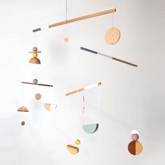 a mobile made out of wood with different shapes and sizes