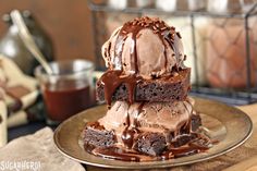 chocolate cake with ice cream on top sitting on a plate