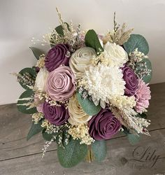 a bouquet of flowers sitting on top of a wooden table