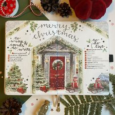 a christmas card with a red door surrounded by pine cones and other holiday decorations on a table