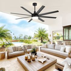 a living room with couches, tables and ceiling fan in the middle of it