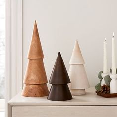 three wooden christmas trees sitting on top of a table