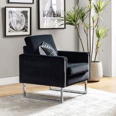 a black chair sitting on top of a white rug next to a potted plant