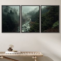 three framed pictures hanging on the wall above a table with a vase and coffee cup