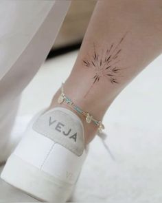 a woman's foot with a small tattoo on her left ankle and the word vera written below it