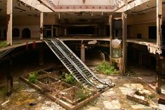 an abandoned building with stairs leading up to the second floor