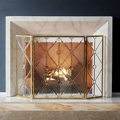 a fireplace with a fire in it and a mirror on the front wall behind it