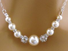 "Sterling Silver Rhinestone Pearl Bridal Necklace, Swarovski Wedding Necklace, Pearl Bridesmaid Necklace, Wedding Jewelry, Pearl Necklace Mother of the Bride Choose your colors - shown with white Swarovski pearls accented with sparkly Swarovski crystals and rhinestone fireballs on a shiny sterling silver chain. Length: 16 inches. Please leave a note at checkout if you need a different length up to 20 inches. Available in Sterling Silver and 14 Carat Gold Fill **Additional CUSTOM COLORS available Crystal Pearl Necklace With Rhinestones For Wedding, White Rhinestone Necklace With Pearl Chain For Wedding, White Crystal Rhinestone Necklace For Wedding, Pearl White Rhinestone Necklace For Wedding, Wedding Rhinestone Necklace With Pearl Chain, White Rhinestone Wedding Necklace With Sparkling Stones, Wedding Jewelry With Pearl And Rhinestones, Elegant White Rhinestone Necklace For Wedding, Elegant Pearl Necklace With Rhinestones For Wedding