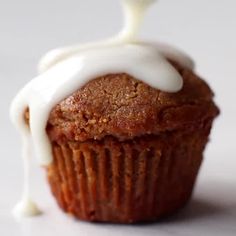 a cupcake with icing on top sitting on a table