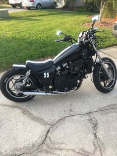 a black motorcycle parked in front of a house