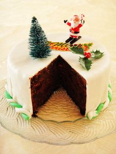 a cake decorated with white frosting and christmas decorations