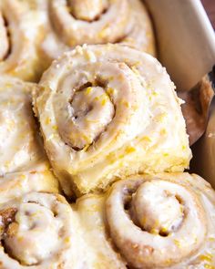 a pan filled with cinnamon rolls covered in icing