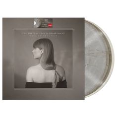 an album cover with a woman's face and long hair in the center, on a gray background