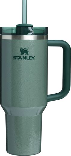 the stanley coffee cup is green and has a straw in it's handle,