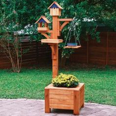 a wooden bird feeder on top of a planter