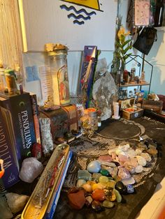 a table topped with lots of different types of rocks and glass bottles on top of it