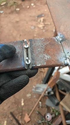 a person holding a piece of metal in their hand