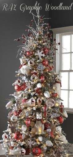 a white christmas tree with red and silver ornaments