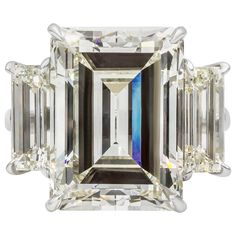 A rare and spectacular engagement ring, showcasing a 14.18 carats emerald cut diamond certified by GIA as M color and VVS2 clarity. Flanked by baguette diamonds weighing 3.81 carats total with M color and VS clarity. Finely made with a platinum mounting. Size 6.25 US, resizable upon request. Roman Malakov is a custom house, specializing in creating anything you can imagine. If you would like to receive a special quote on a custom piece, please message or call us. Emerald Cut Diamond Engagement, Emerald Cut Diamond Ring, Emerald Cut Engagement, Platinum Diamond Rings, Emerald Cut Rings, Emerald Diamond Ring, Modern Engagement Rings, Engagement Ring Diamond Cut, Three Stone Diamond