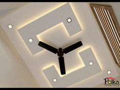 a ceiling with lights and a clock on the wall above it in a living room