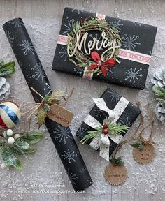 christmas presents are laid out on the snow and decorated with ribbons, pine cones, and ornaments